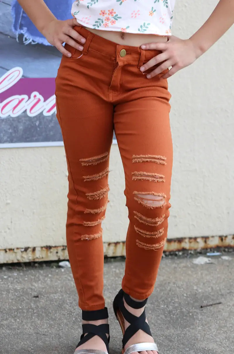 RUST RIPPED SKINNY JEANS.